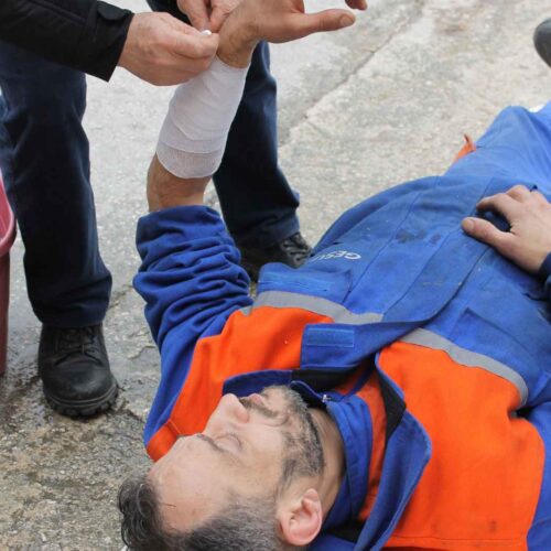 First Aider assisting a victim with a bandage.