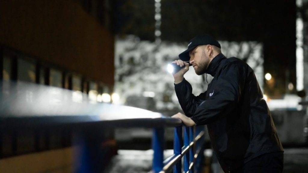 a private security guard with a flashlight 