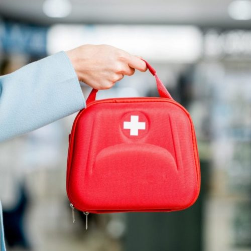 Person holding a first aid kit.