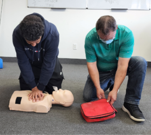 Adult chest compressions practised on a training manikin at a Coast2Coast facility