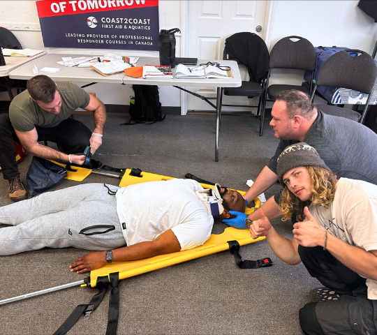 Students backboarding a patient during Emergency Medical Responder training in North York