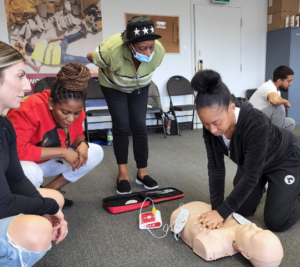 Using an AED trainer during a Coast2Coast class