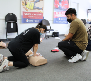 Chest compressions practised on an adult manikin during a Coast2Coast class