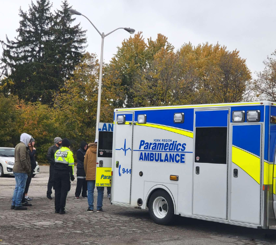 EMR students loading a patient into an ambulance during scenario training
