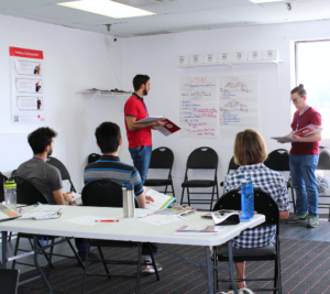 A first aid instructor candidate practising a teaching demonstration