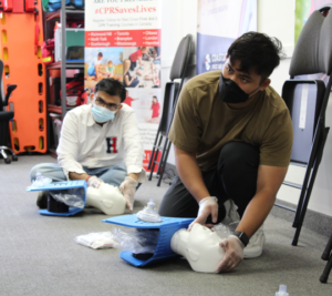 CPR compressions on an adult manikin during hands-on skills testing with automated external defibrillator