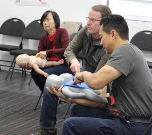 Infant choking first aid treatment on a training manikin, part of CPR/AED Level C