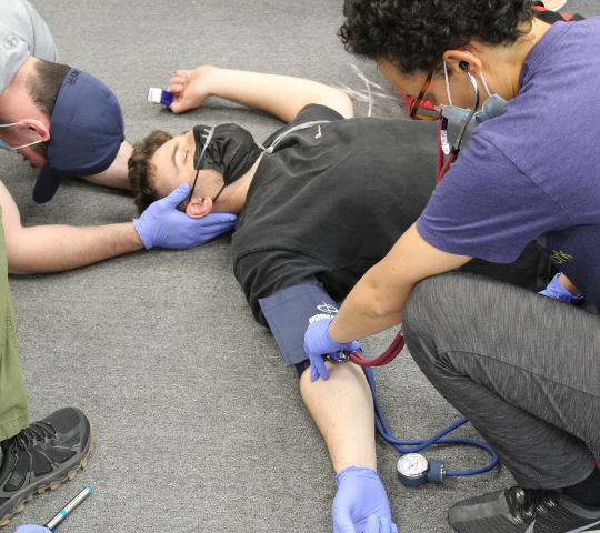 Two students performing a primary patient assessment during First Responder training in Scarborough