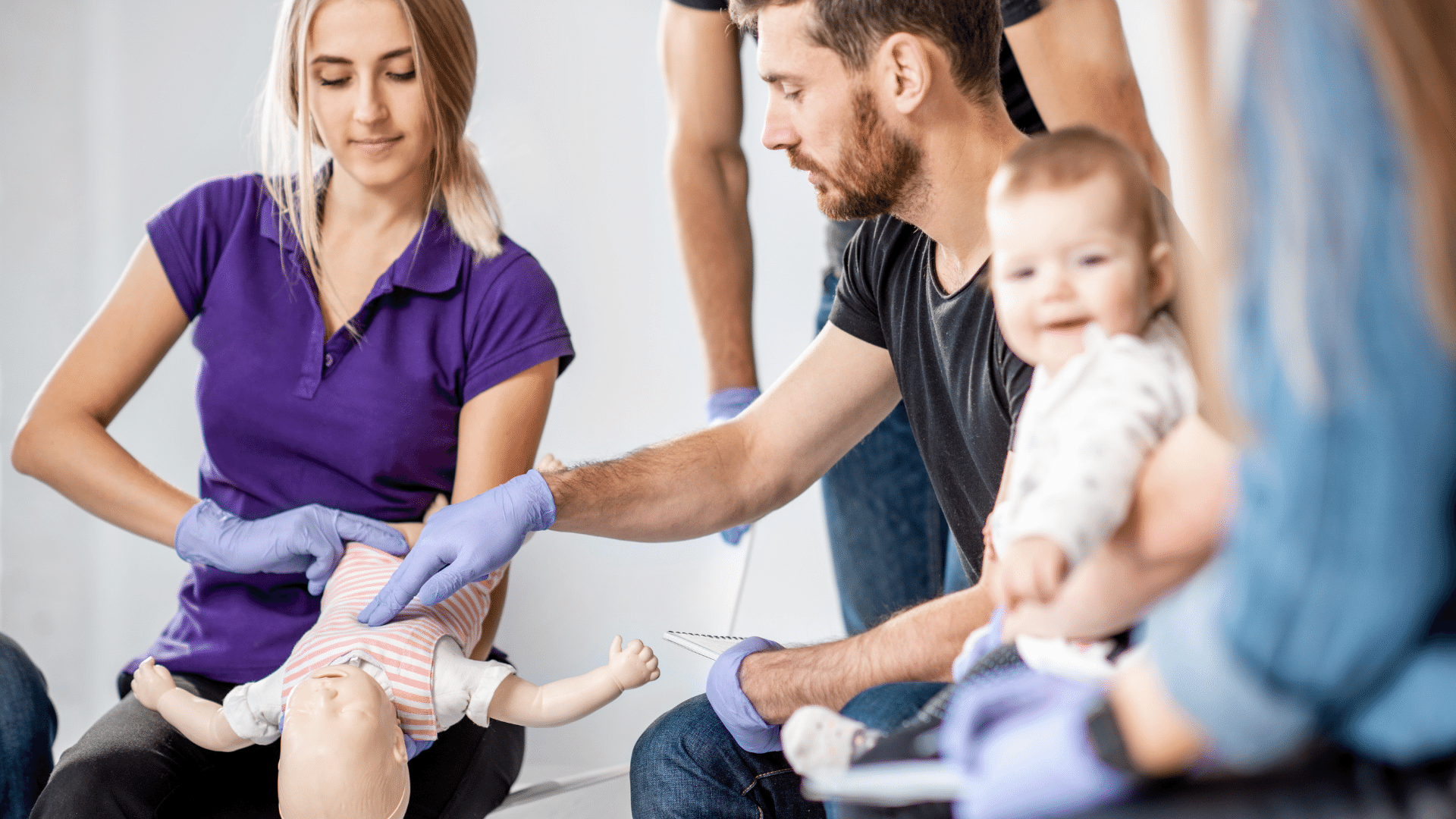 Person performing CPR on a baby dummy.