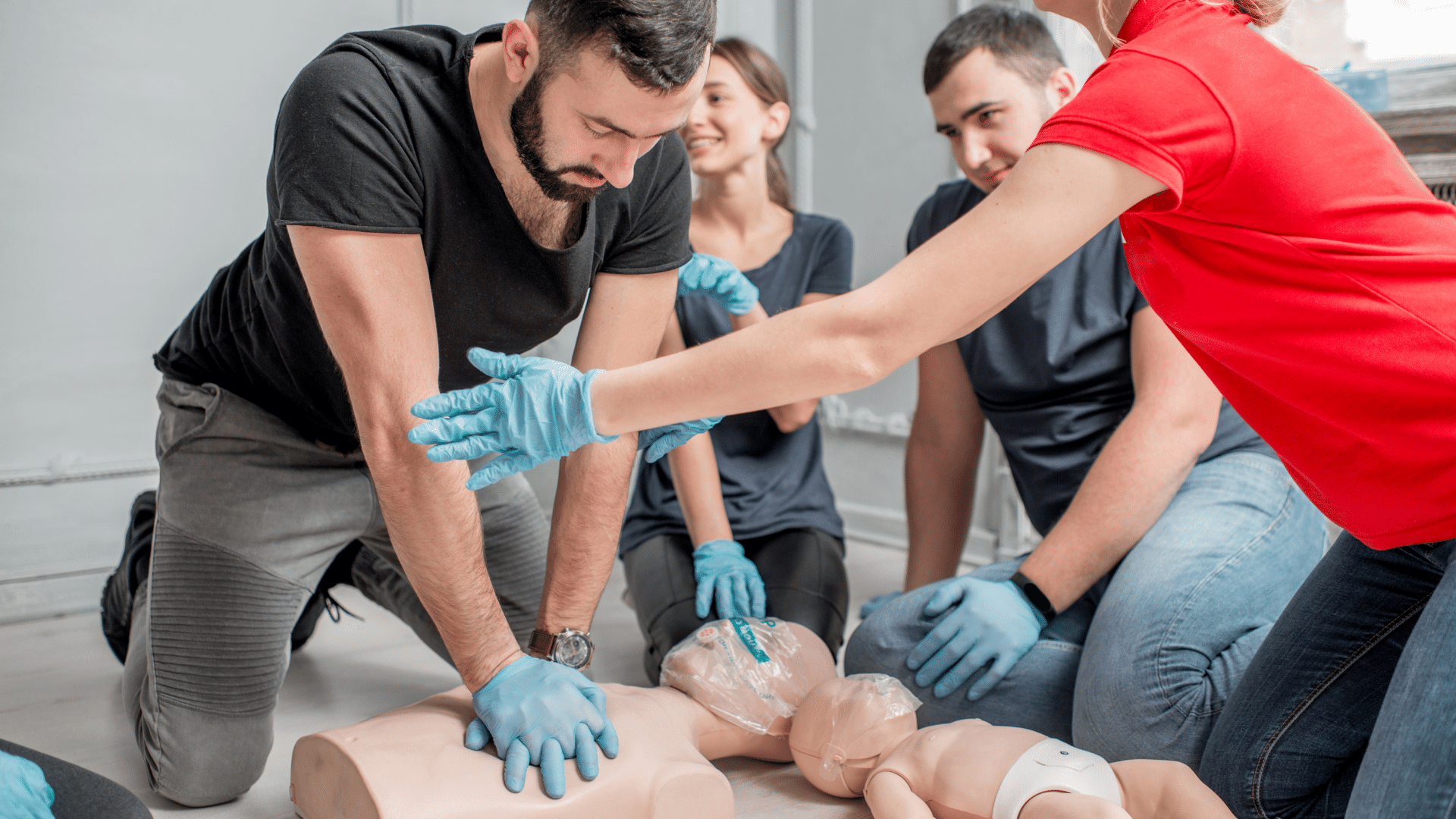 Instructor teaching how to perfrom CPR on a dummy
