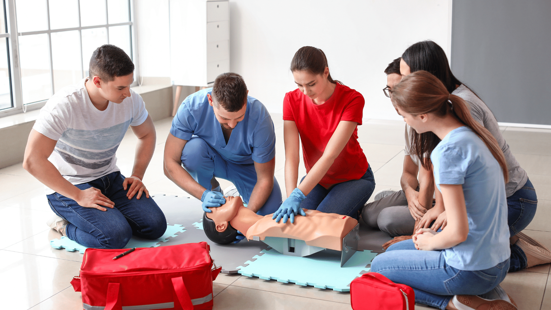 Instructors demonstrating CPR on a Mannequin