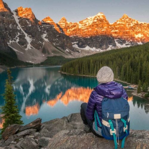 Hiker appreciating the mountains and a lake in Alberta
