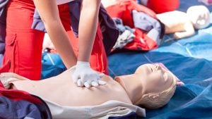 Student Practicing CPR on mannequins during CPR Certification class in Los Angeles California