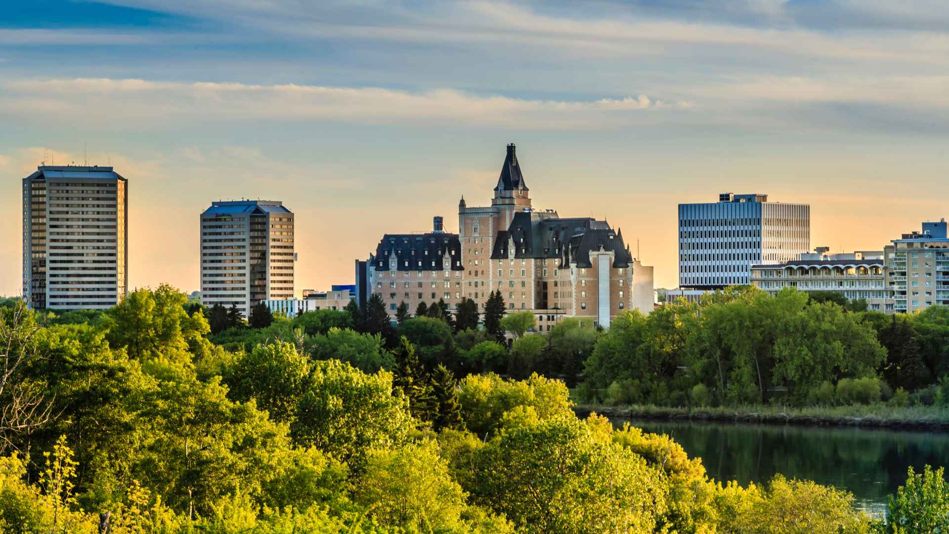 skyline of saskatoon with trees in foreground and buildings in background