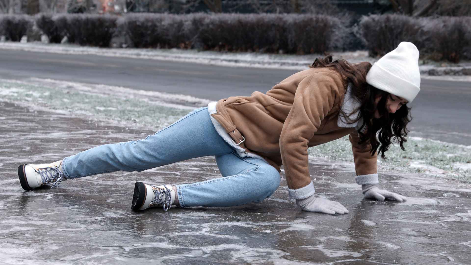 woman who has fallen on ice in the winter time