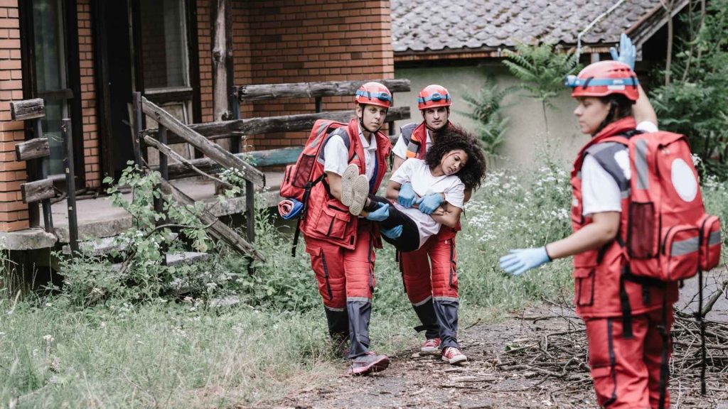 first aid responders carrying someone to safety
