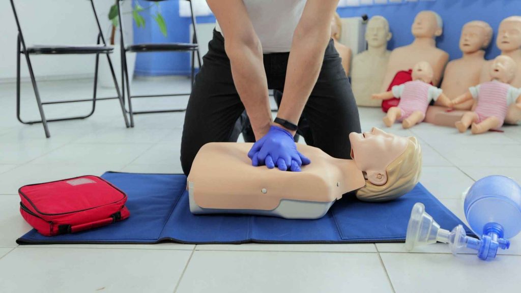 First Aid and CPR training, an instructor and a dummy coast2coast