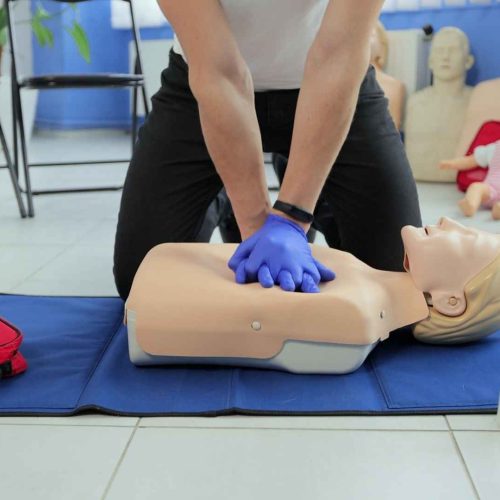 First Aid and CPR training, an instructor and a dummy coast2coast