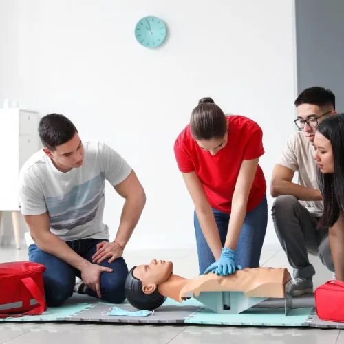 Group of adults practicing CPR chest compressions on a manikin during Coast2Coast CPR Week 2026 certification training